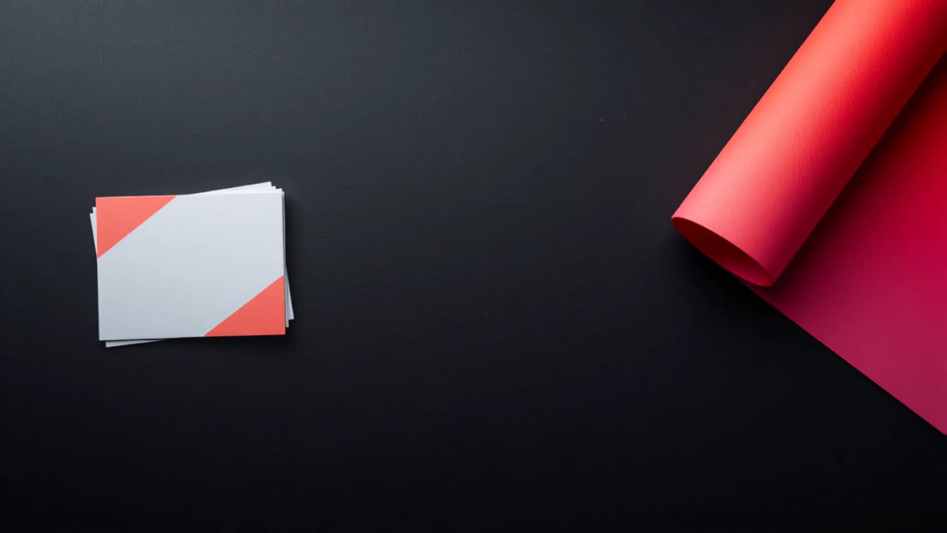 Business cards and a rolled poster print in a bold gradient colourway